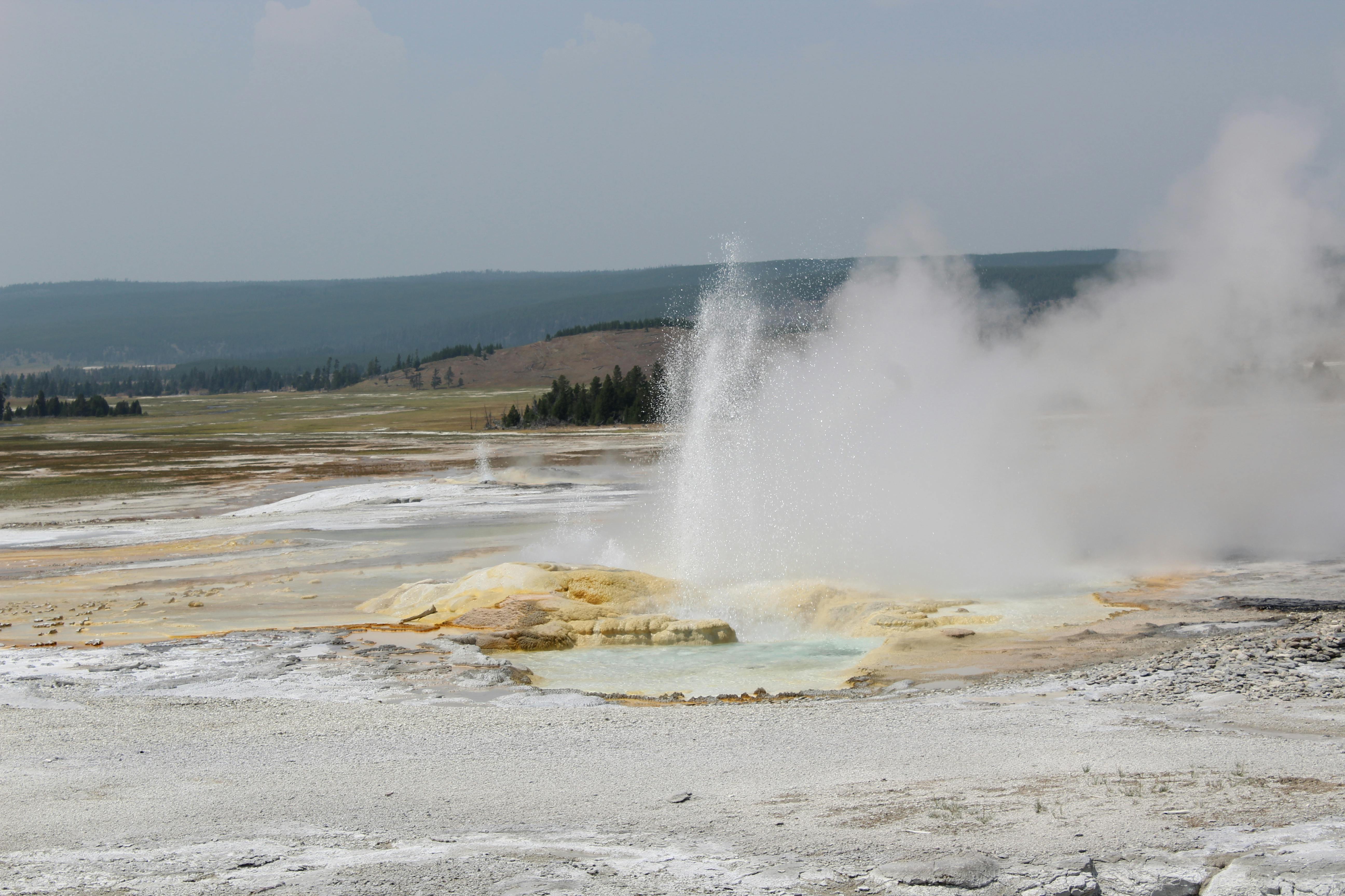 Strokkur geyser erupting with tourists watching