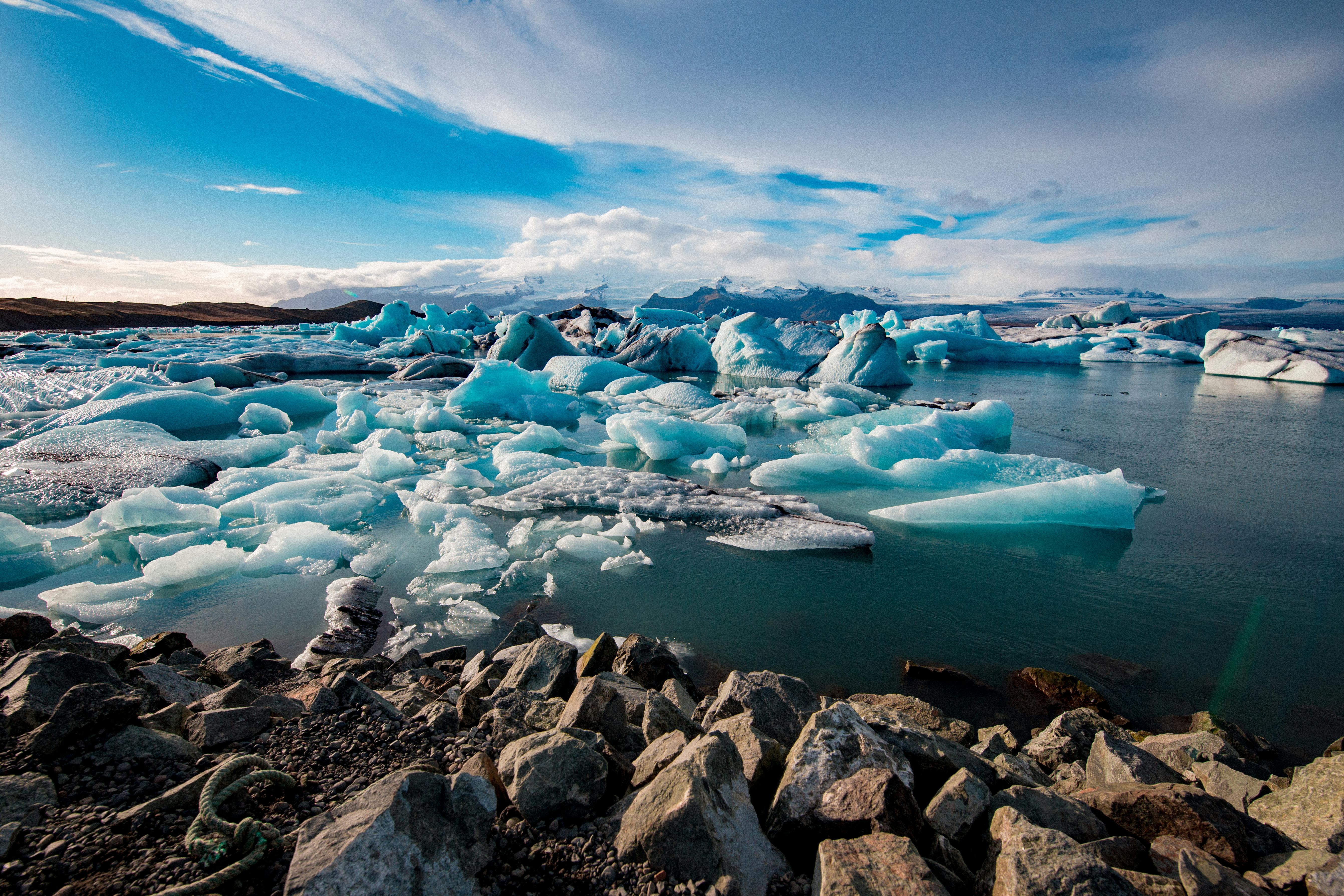 Icebergs floating in Jökulsárlón glacier lagoon with mountains in background